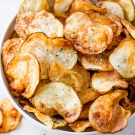 A bowl of air fryer potato chips with seasonings