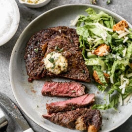 Air fryer steak on a plate with herb butter