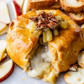 Cheese oozing out of puff pastry with baked brie inside