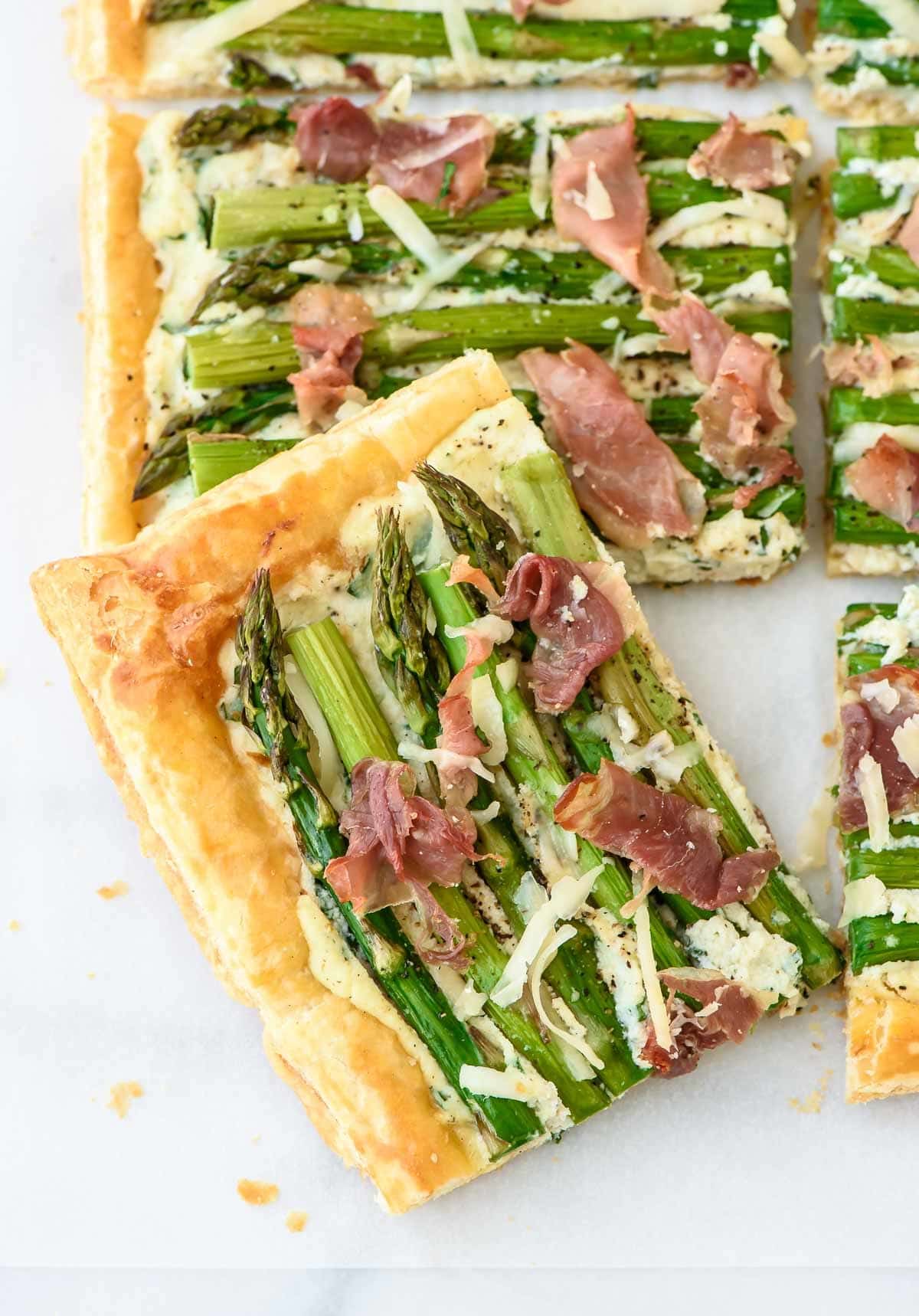 Pieces of asparagus tart with prosciutto