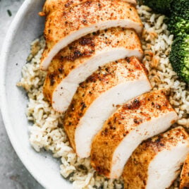 A sliced oven roasted chicken breast that looks juicy and well seasoned