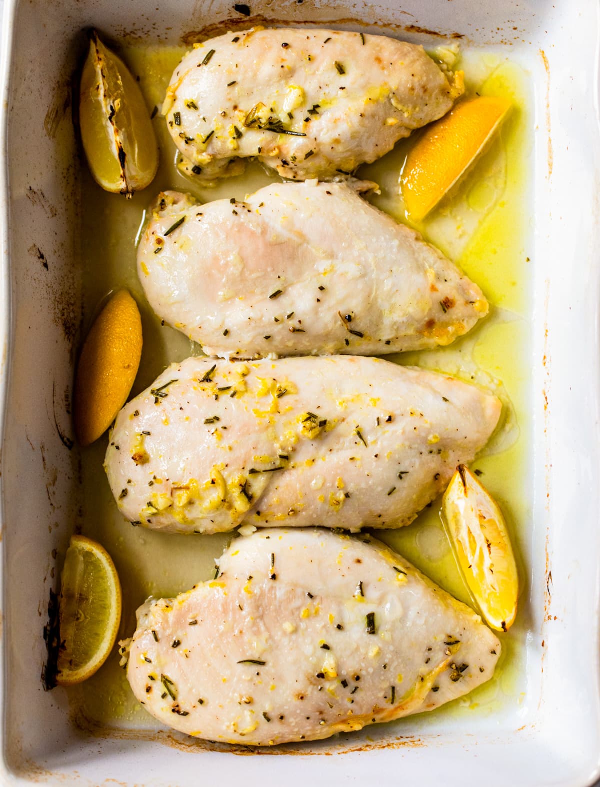 Overhead view of baked lemon chicken in pan