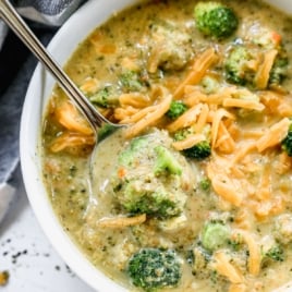best broccoli and cheddar soup in a bowl topped with cheddar cheese