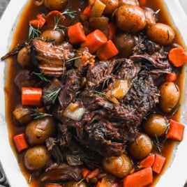 best crockpot roast with gravy, potatoes, and carrots