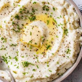 Cauliflower mashed potatoes in a bowl with chives and butter