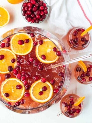 Easy, refreshing, DELICIOUS Sparkling Christmas Punch for a crowd! With champagne, rum, cranberry, and apple cider. Not to sweet, spiked, and so red and festive! Recipe includes nonalcoholic option.