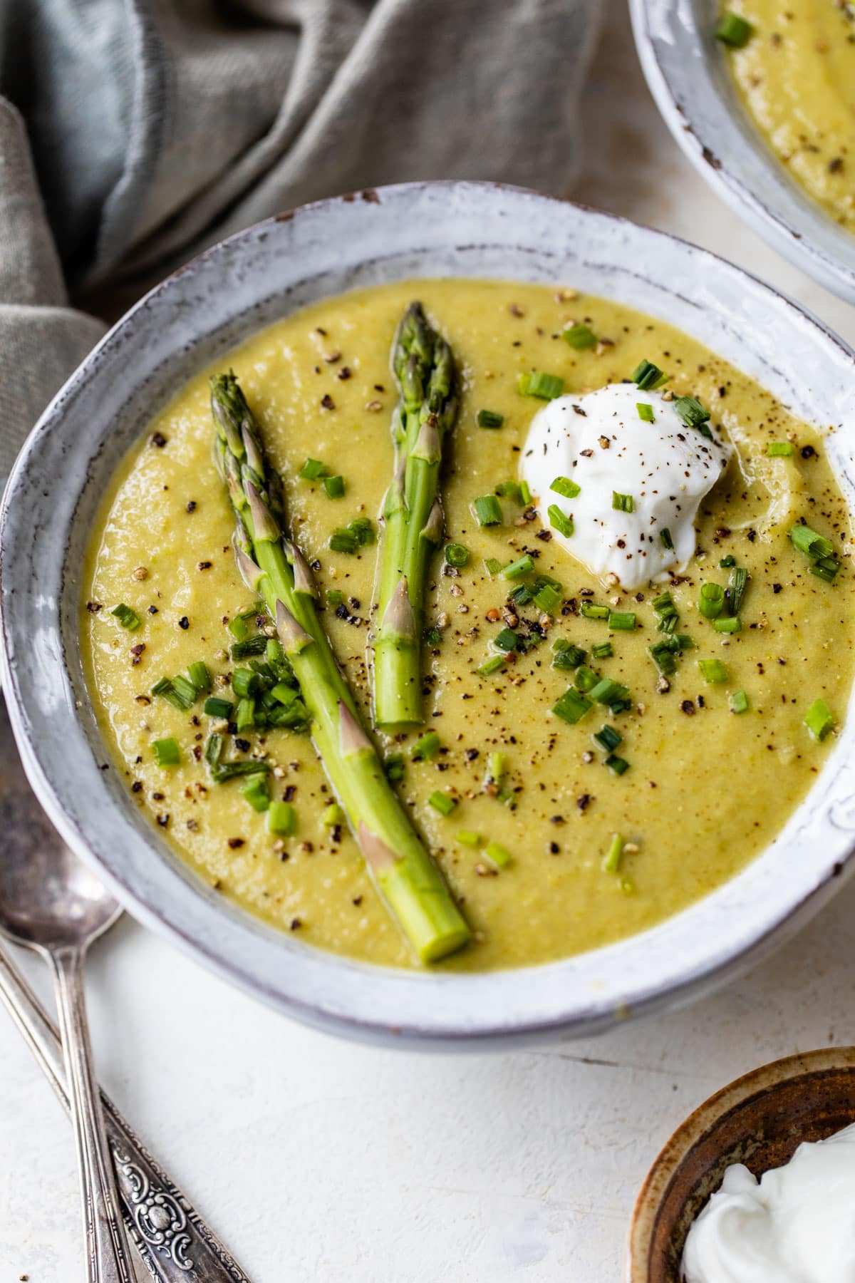 Healthy Asparagus Soup in a bowl with Greek yogurt