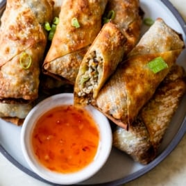 recipe for air fryer egg rolls on a plate with sticky sauce