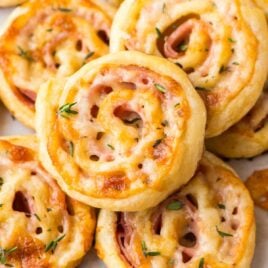 Easy Ham and Cheese Pinwheels with Puff Pastry. Just FOUR ingredients! Everyone loves this simple and delicious appetizer recipe. Easy to make ahead and perfect for holiday parties too! Recipe at wellplated.com | @wellplated