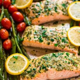 Easy Sheet Pan Baked Garlic Salmon with Lemon Butter and Veggies. Healthy, ready in 30 minutes, and everything cooks on ONE pan for easy clean up! Try it with green beans and asparagus, roasted tomatoes, or any of your favorite vegetables. {gluten free} Recipe at wellplated.com | @wellplated