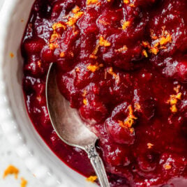 Cranberry sauce with orange juice and cinnamon in a bowl with a spoon