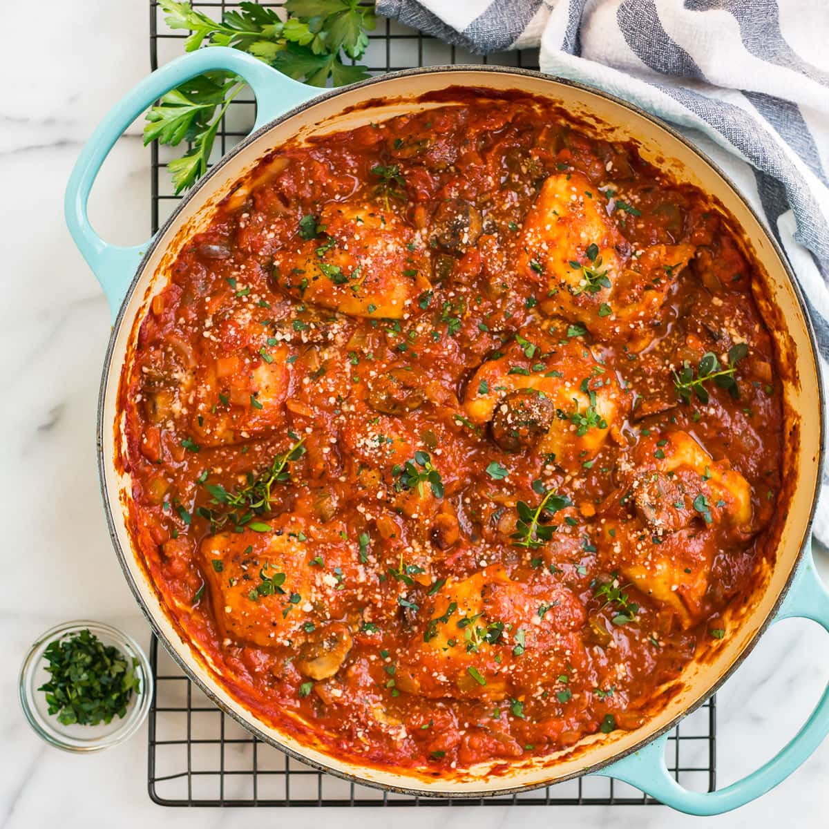 A Dutch oven with fast chicken cacciatore sauce and chicken thighs