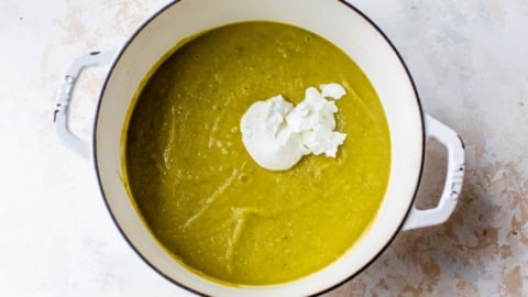 cream of asparagus soup with greek yogurt in a large pot
