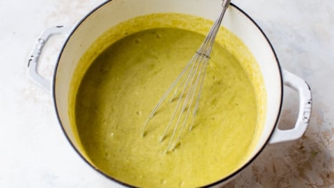 whisking together creamy vegetarian asparagus soup
