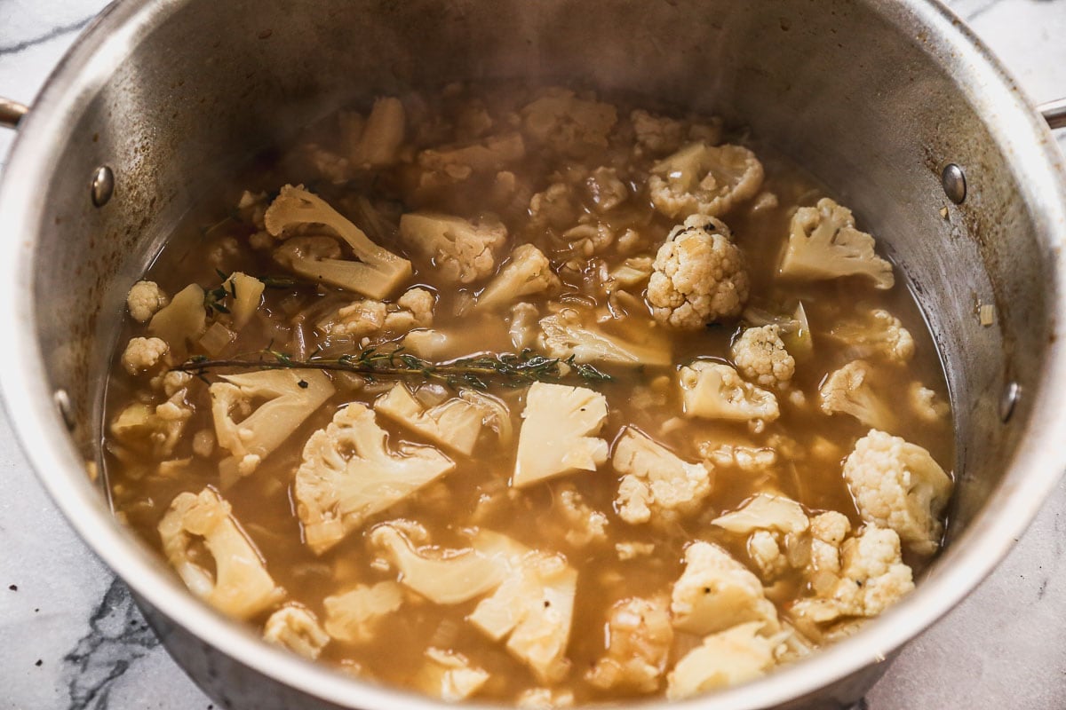 cauliflower simmered in pot of broth
