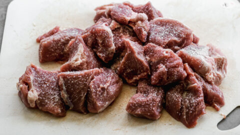 Seasoned meat on a cutting board