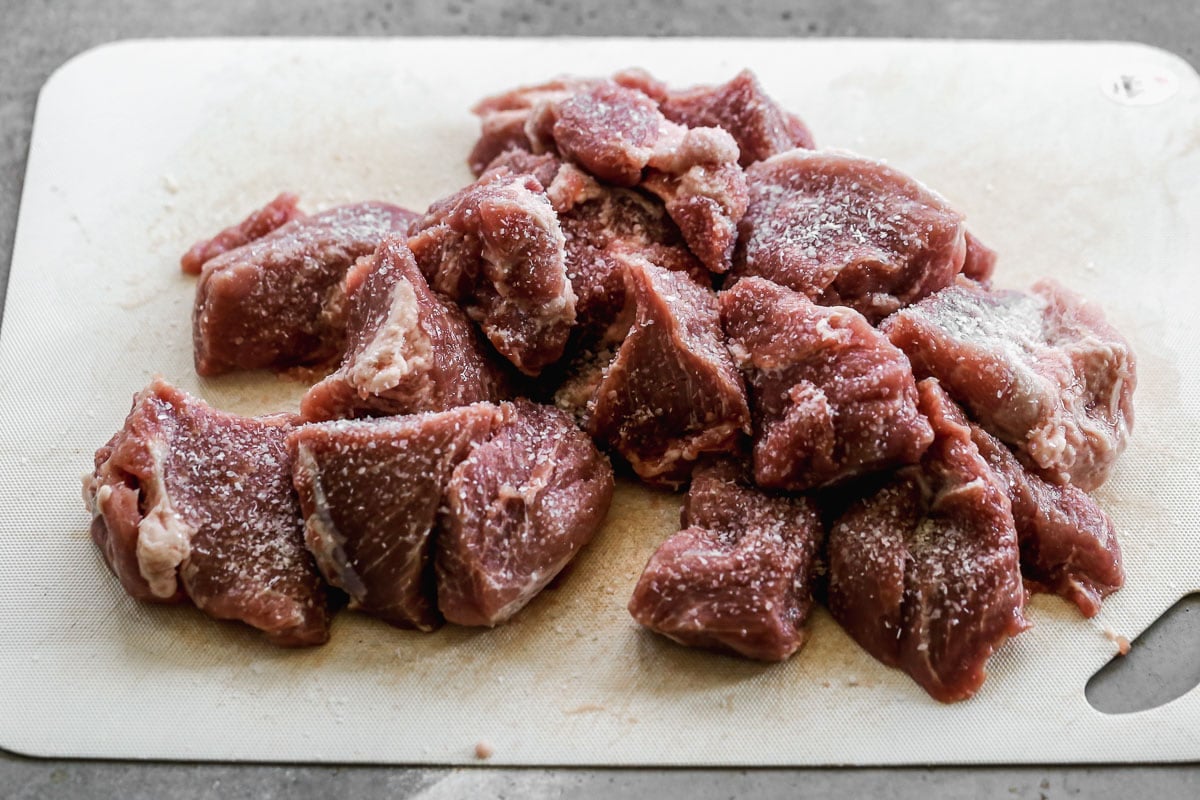 Seasoned meat on a cutting board