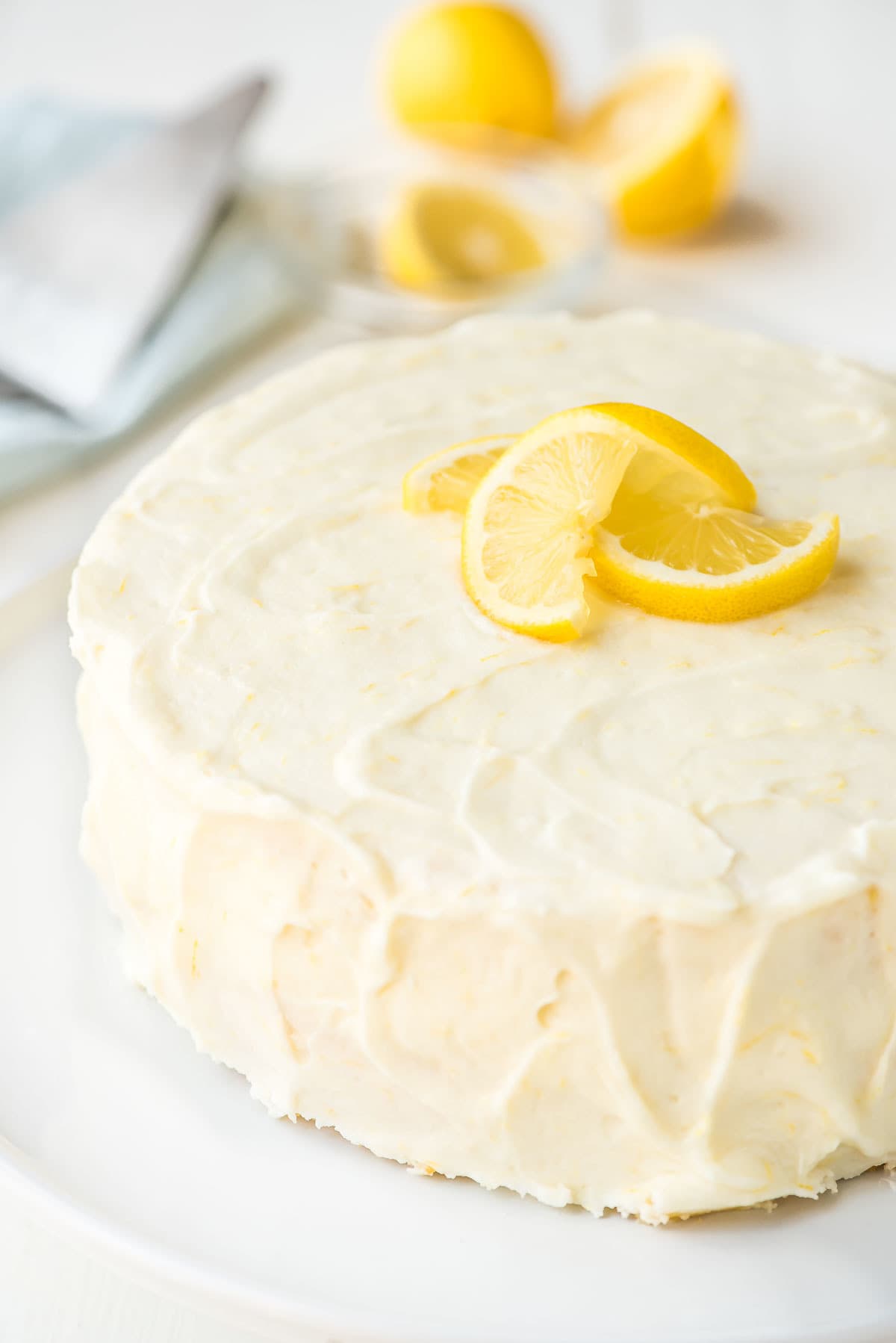 Beautifully frosted lemon cake with lemon cream cheese frosting and lemon slices on top