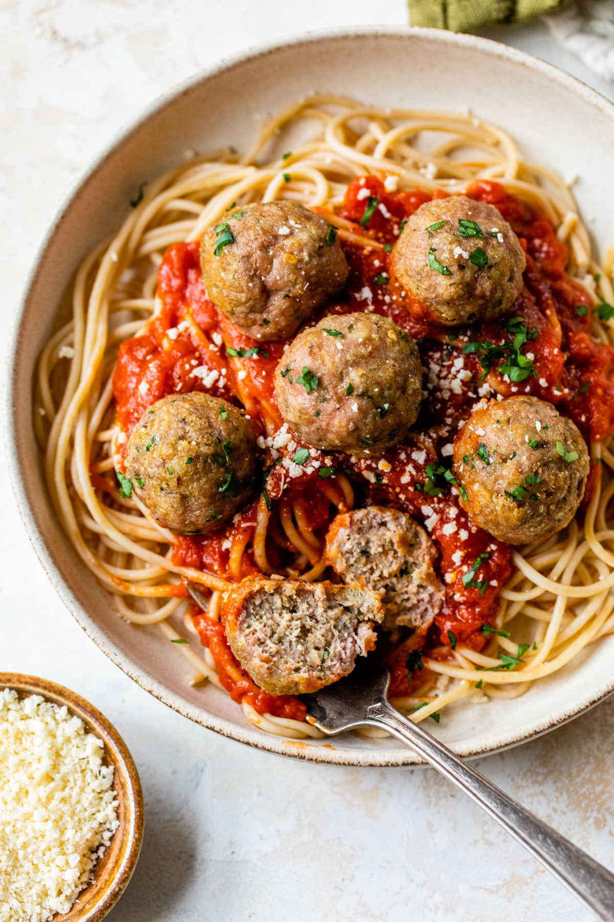 healthy baked turkey meatballs in a bowl with noodles and sauce