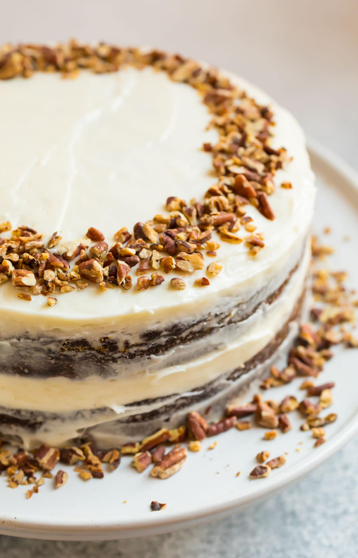 A beautifully decorated almond flour gluten free carrot cake topped with nuts