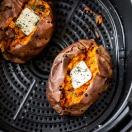 Two air fryer sweet potatoes with butter