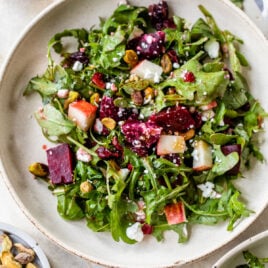 A white plate with beet salad