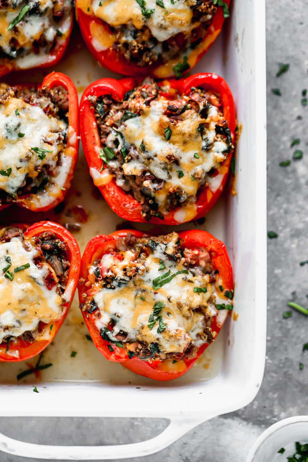 Baked stuffed peppers with rice in a white casserole dish