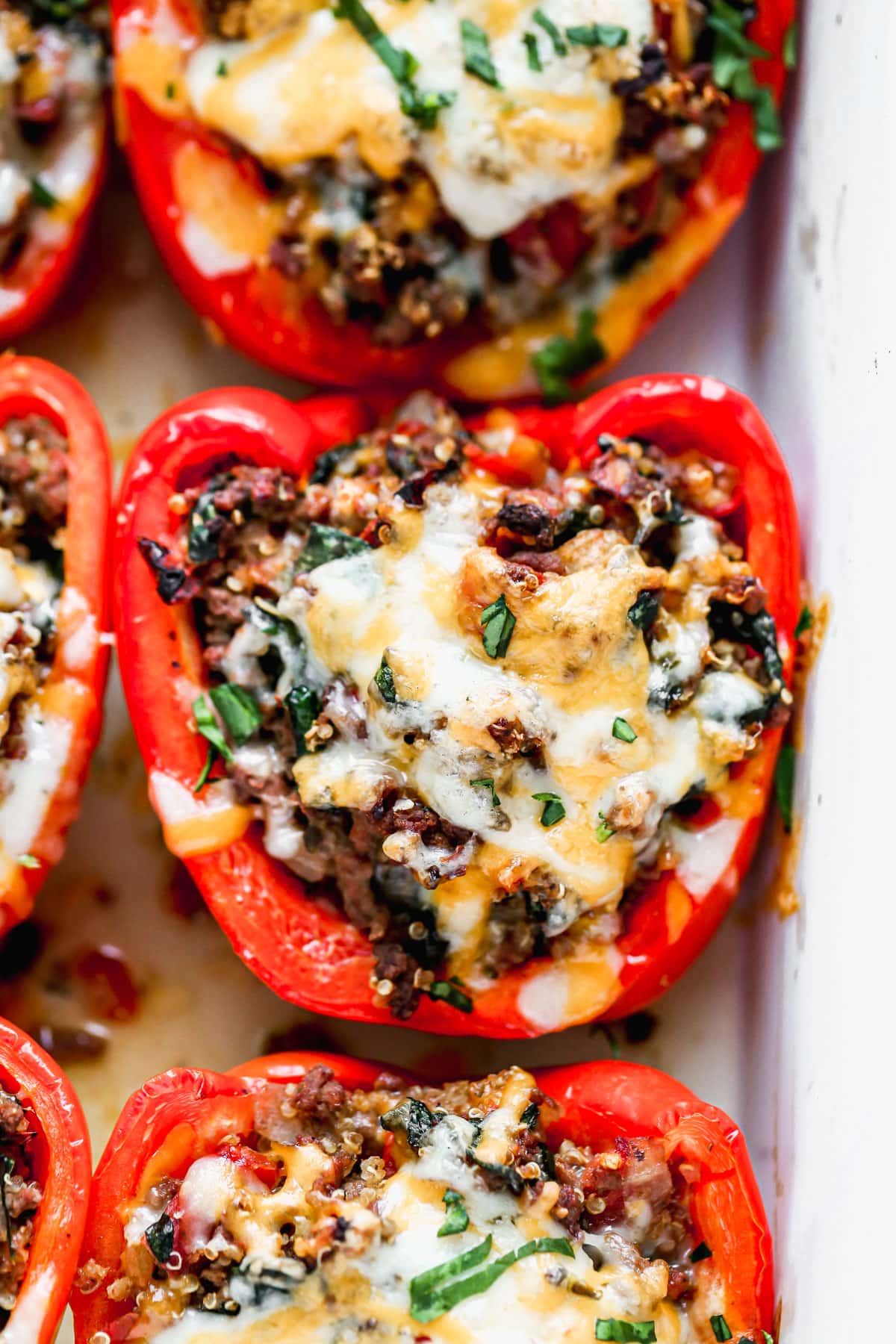 Recipe for stuffed peppers with rice and cheese arranged in a casserole and baked in the oven
