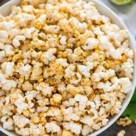 Easy “Cheesy” Taco Popcorn. Chili powder, fresh lime zest, and nutritional yeast make a delicious, healthy, dairy free party appetizer or office snack. Perfect for movie nights! #popcorn #tacopopcorn #dairyfree #healthysnack #healthyappetizer