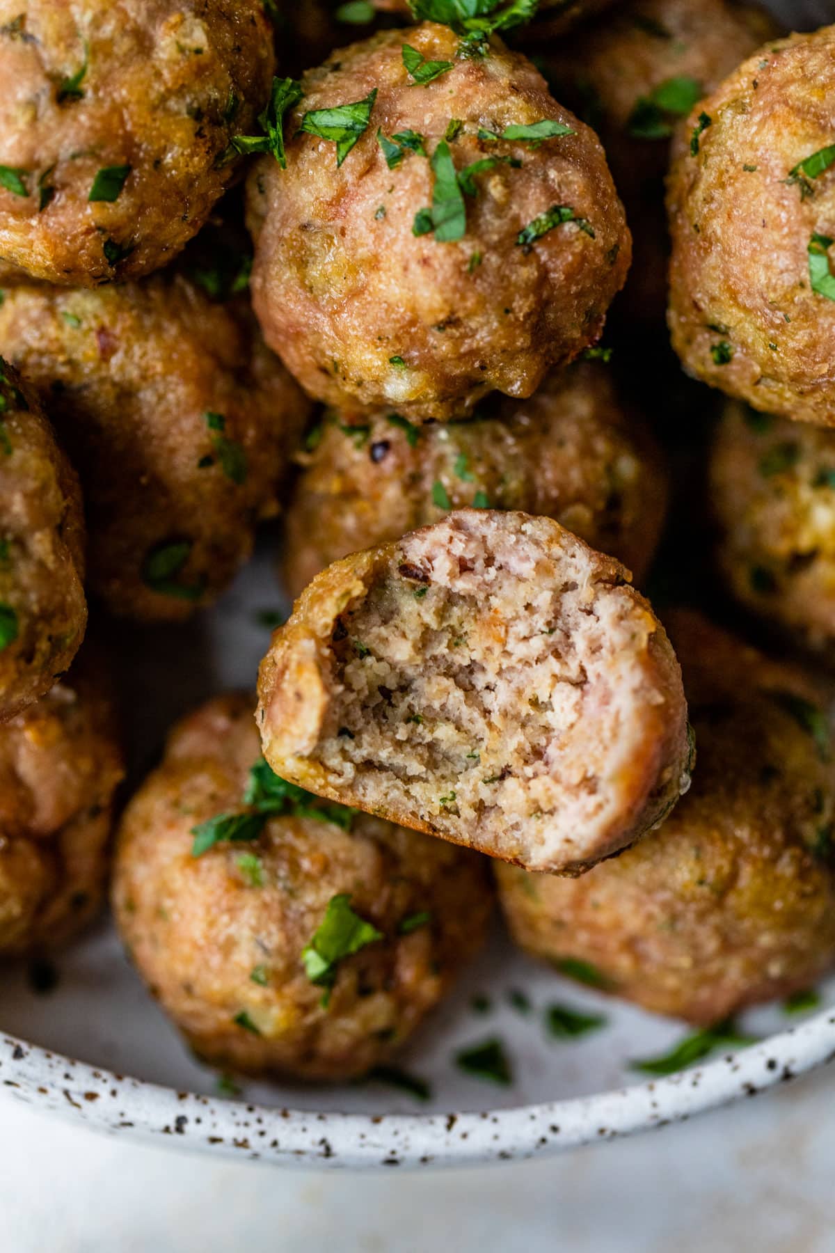baked turkey meatballs with a bite taken out of